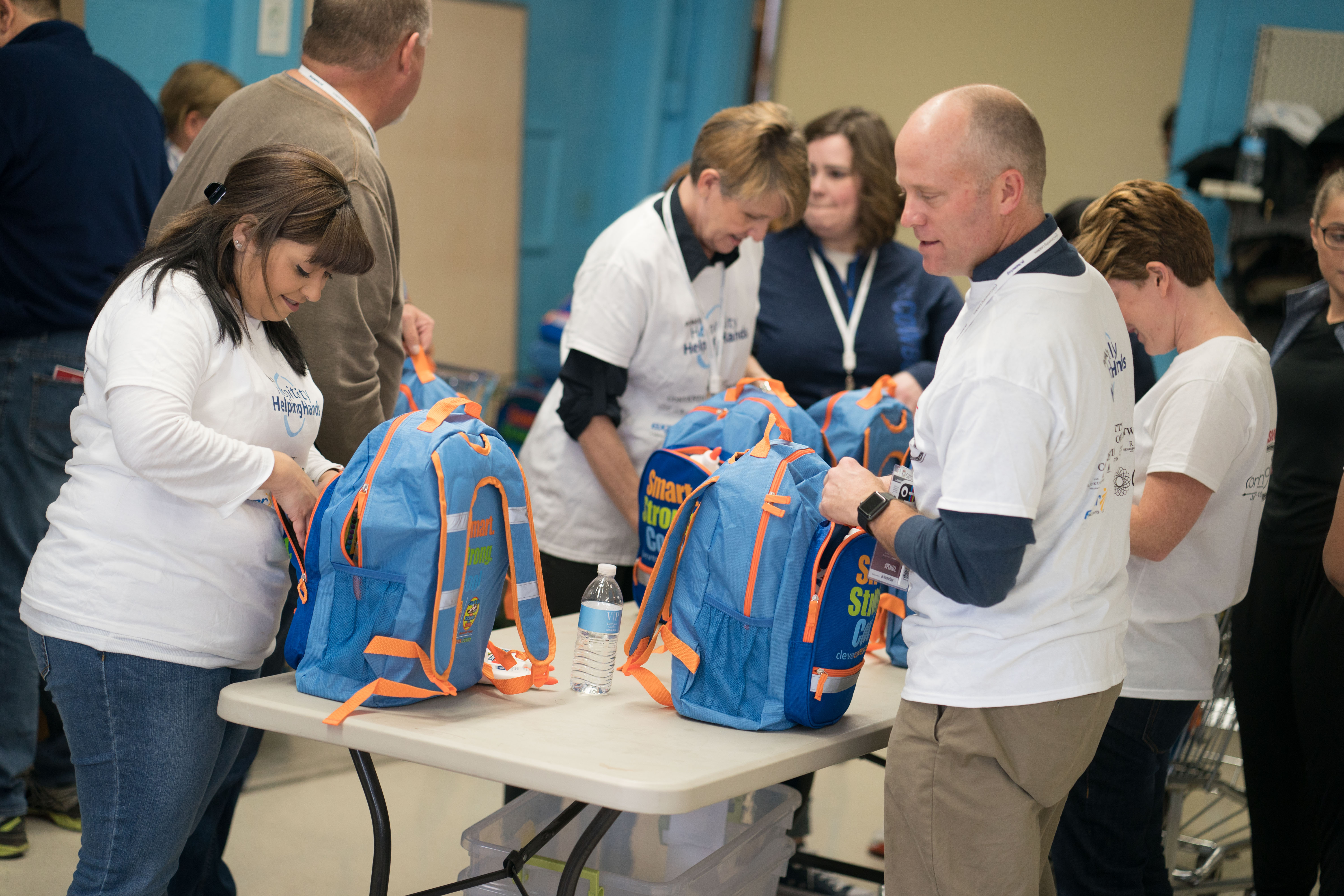 Hospitality Helping Hands PCMA volunteers fill school backpacks