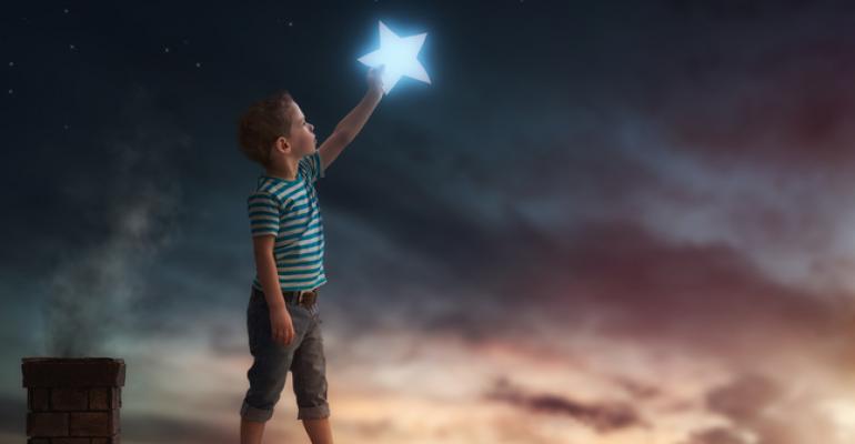 Boy on rooftop touching a star