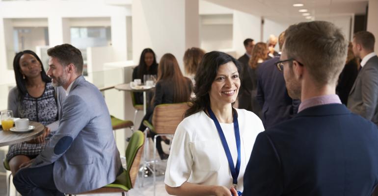 People chatting during a meeting coffee break