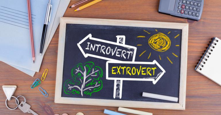 Signs reading "introvert" and "extrovert"