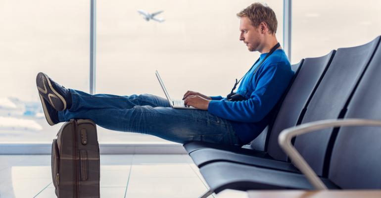 Man using a laptop at the airport