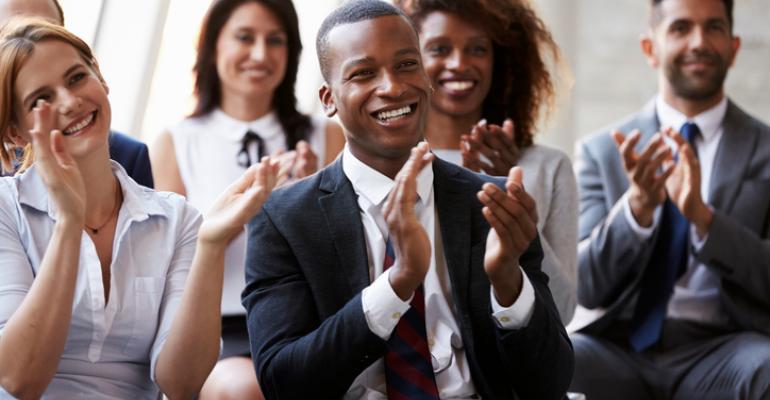 Audience members clapping