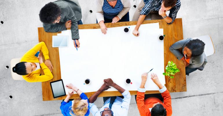 People sitting around a table at a meeting