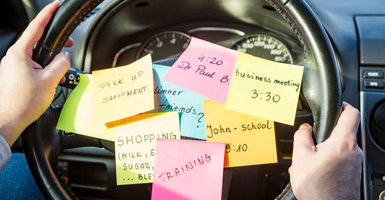 sticky note to-do list on a steering wheel