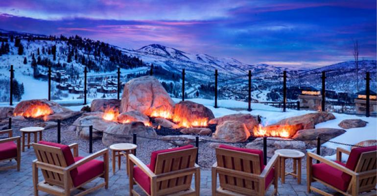Mountain Terrace at St Regis Deer Valley guests can warm themselves at the fire pit while catching spectacular Wasatch Mountain views