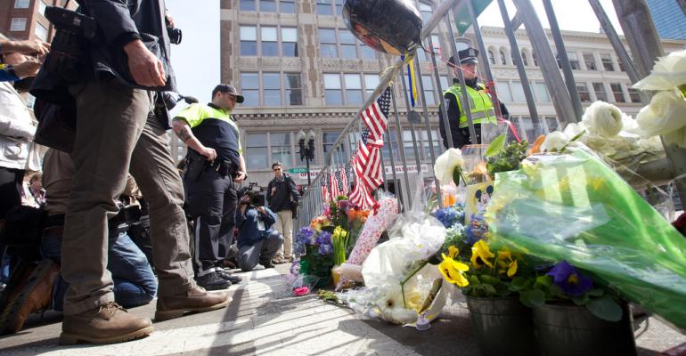 People leave flowers and flags to honor those injured and killed by the Boston Marathon bombing
