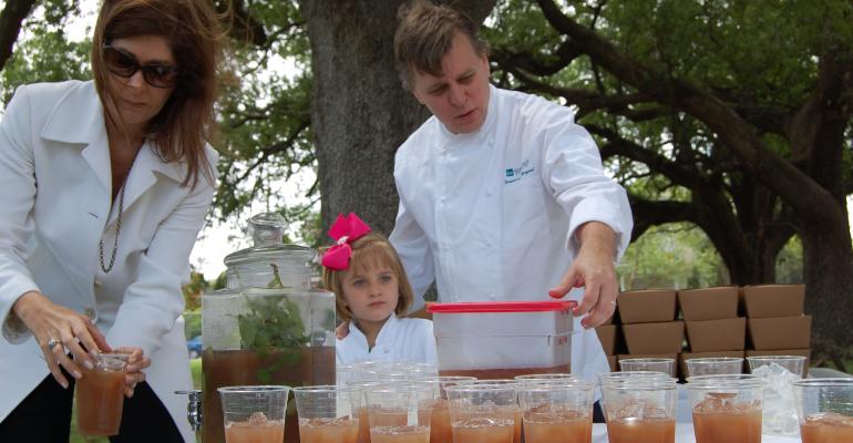 New Orleans chef Dominique Macquet serving mintinfused iced tea with his wife Wendy and daughter Nadya at a local event will be one of the experts participating in the Morial39s Farm to Table symposium