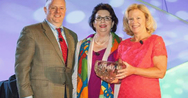 Sue Huff immediate past president of HCEA and director of Global Conventions Medtronic Inc right receives her Distinguished Service Award fromDiane Benson CTSM president of HCEA and Americas exhibits leader GE Healthcare center and Mike Pennington CAE executive vice president of HCEA left Photo by Gary Michael Prochorchik Exposures Ltd 