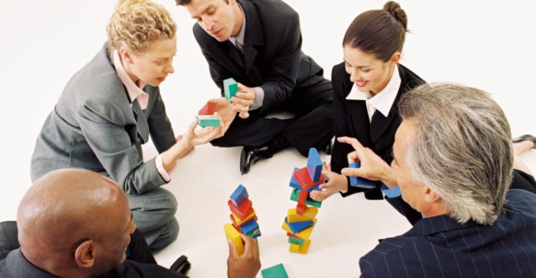 business people playing with blocks