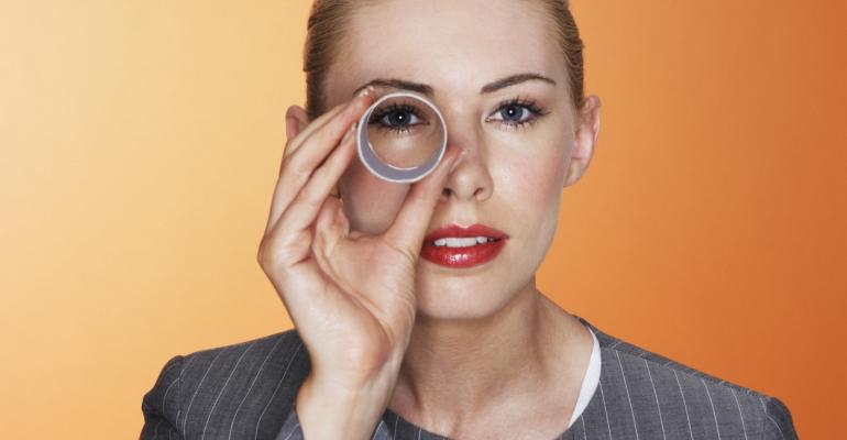 Woman peering through glass