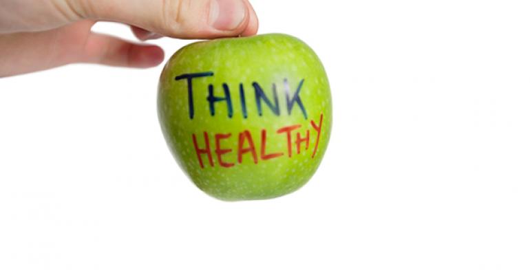 Hand holding apple with think healthy written on it