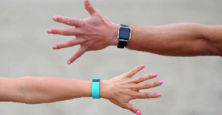 Male and female arms wearing Fitbits