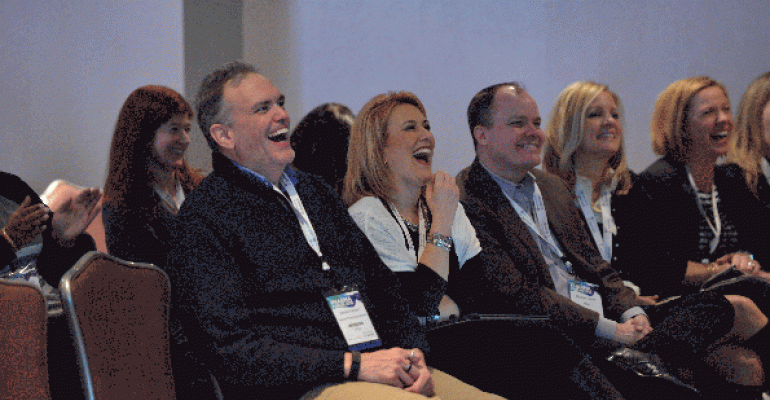 People laughing at a conference