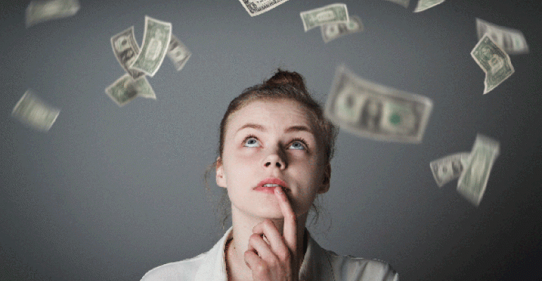 Woman looking up at dollars falling through the air