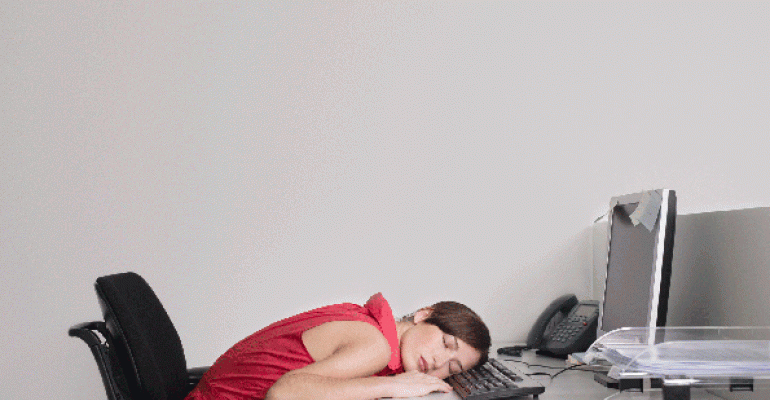 Woman sleeping at her desk