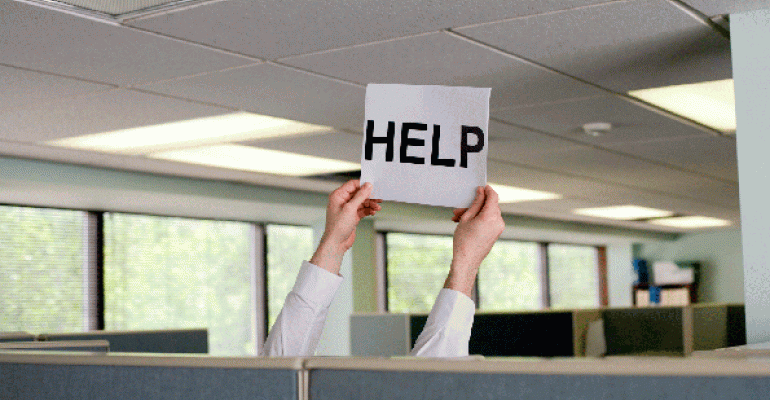 Hands in cubicle holding up Help sign