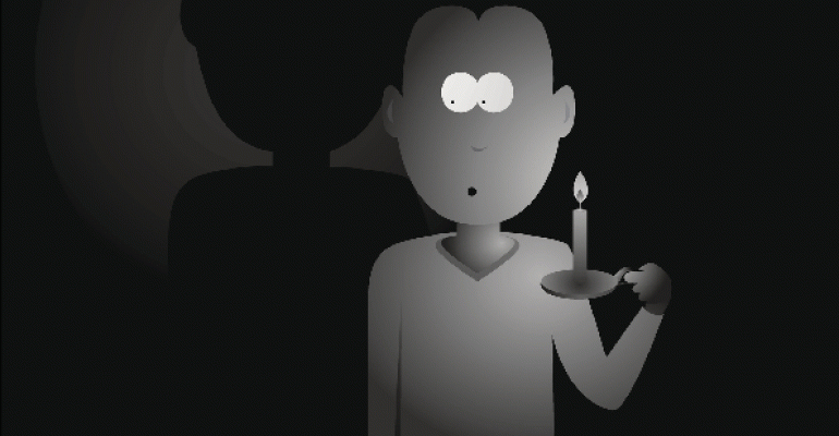 Man holding candle in the dark