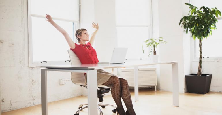 Woman at desk stretching