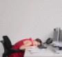 Woman sleeping at her desk