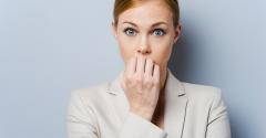 Business woman biting fingernails nervously