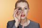 Woman peering through glass