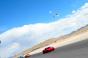 Cars racing on SPEEDVEGAS track with helicopter overhead