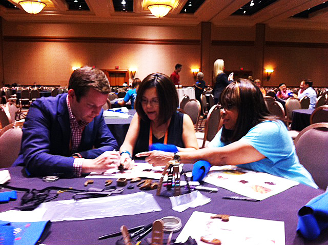 (Left to right): Ben Alderman, American Express; Jennifer Cheung Cline, Hello! Las Vegas Destination Management; and Pat Moore, Mattel, building teamwork and relationships along with a prosthetic hand at the Helping Hands: Connecting Heads, Hands, and Hearts CSR event.